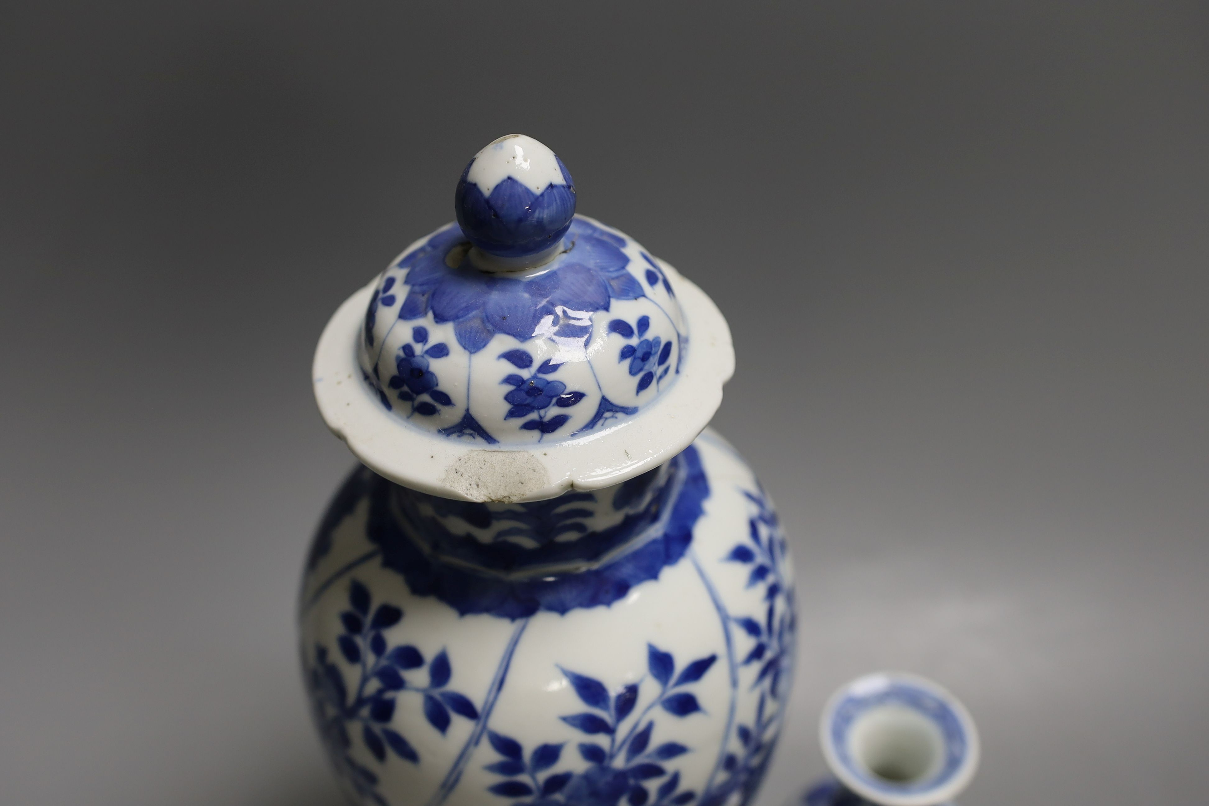 A Chinese blue and white vase and cover, Kangxi mark, 19th century, 26.5cm tall, and a Chinese Kangxi period small vase (2)